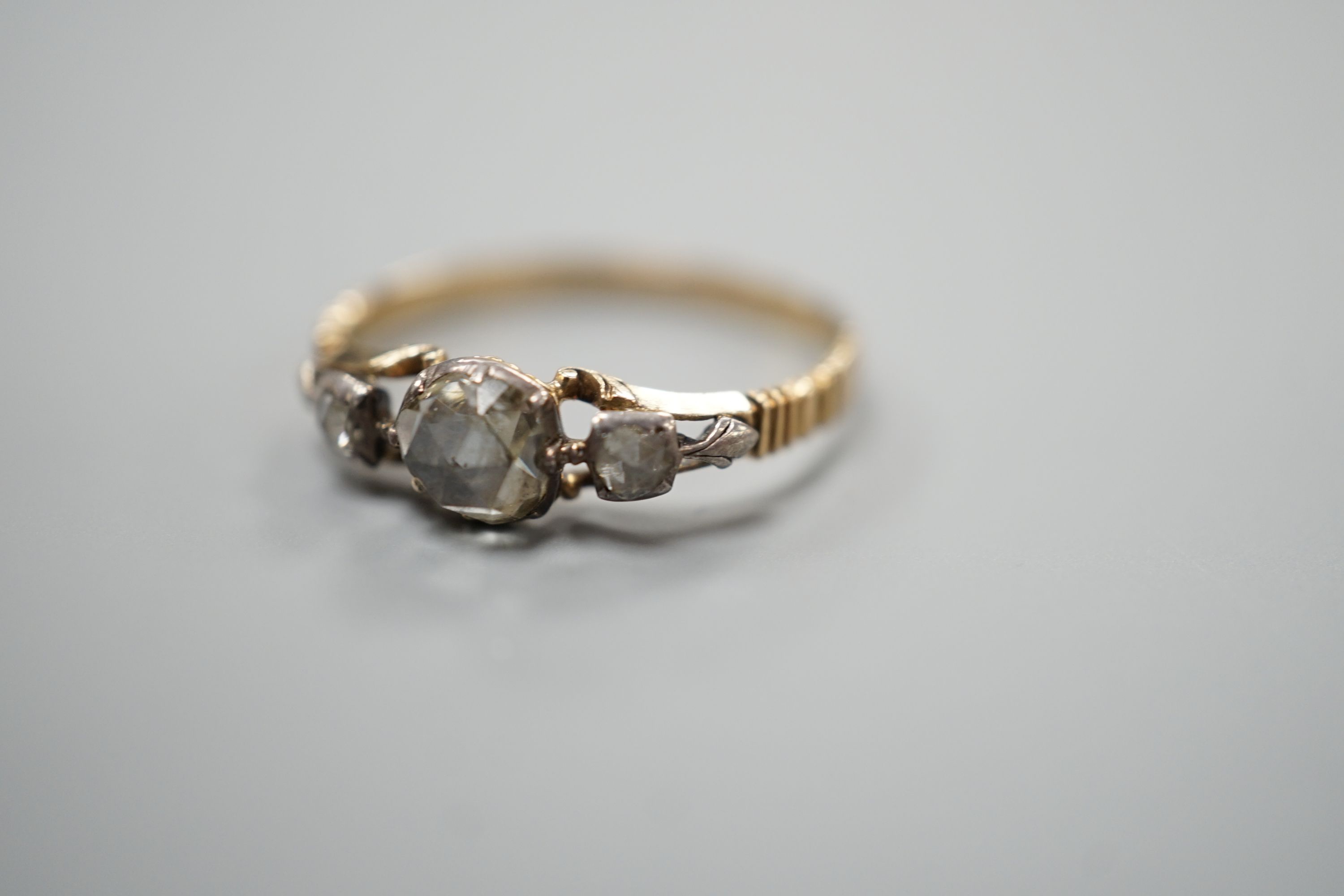 A Georgian yellow metal and three stone rose cut diamond set ring, size O, gross weight 1.9 grams.